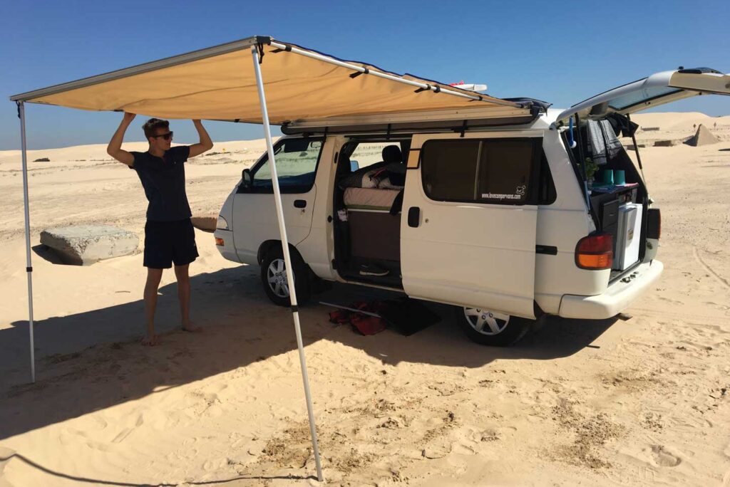 Wild camping Australia campervan awning camping kitchen sand dunes